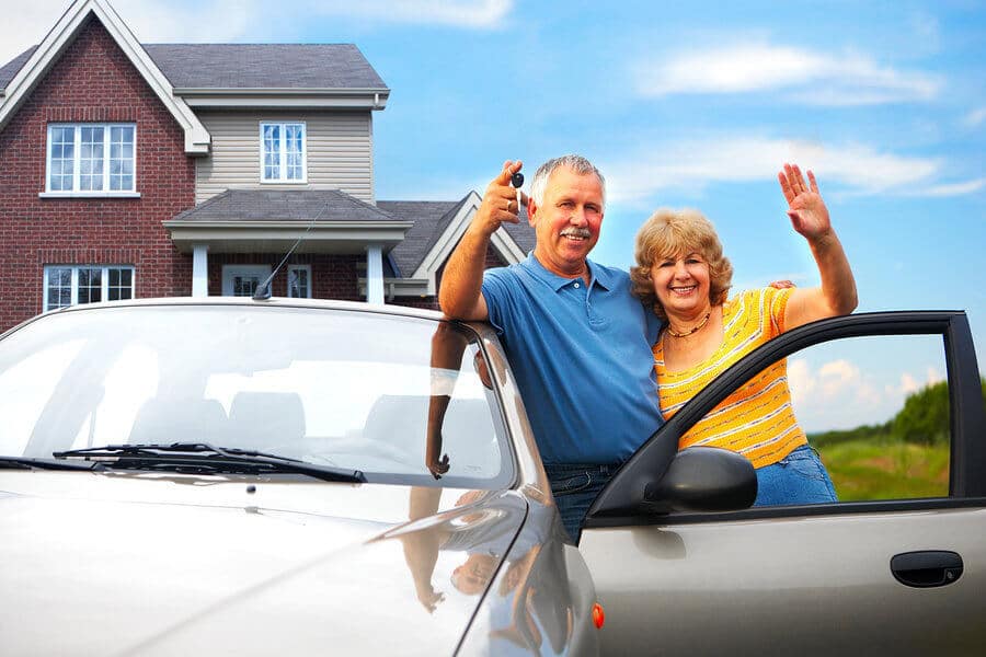 Couple with their car and car insurance