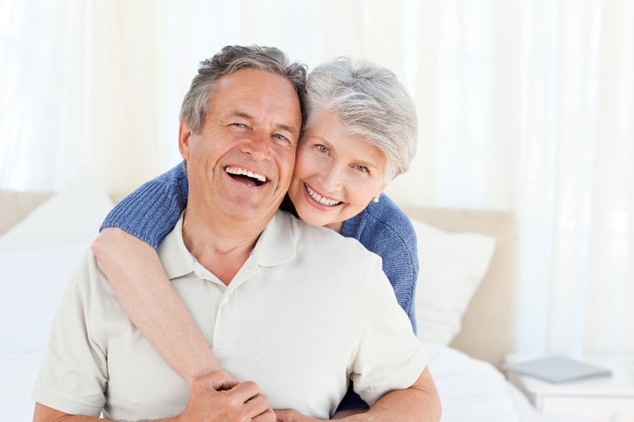 Senior couple looking at the camera  at home